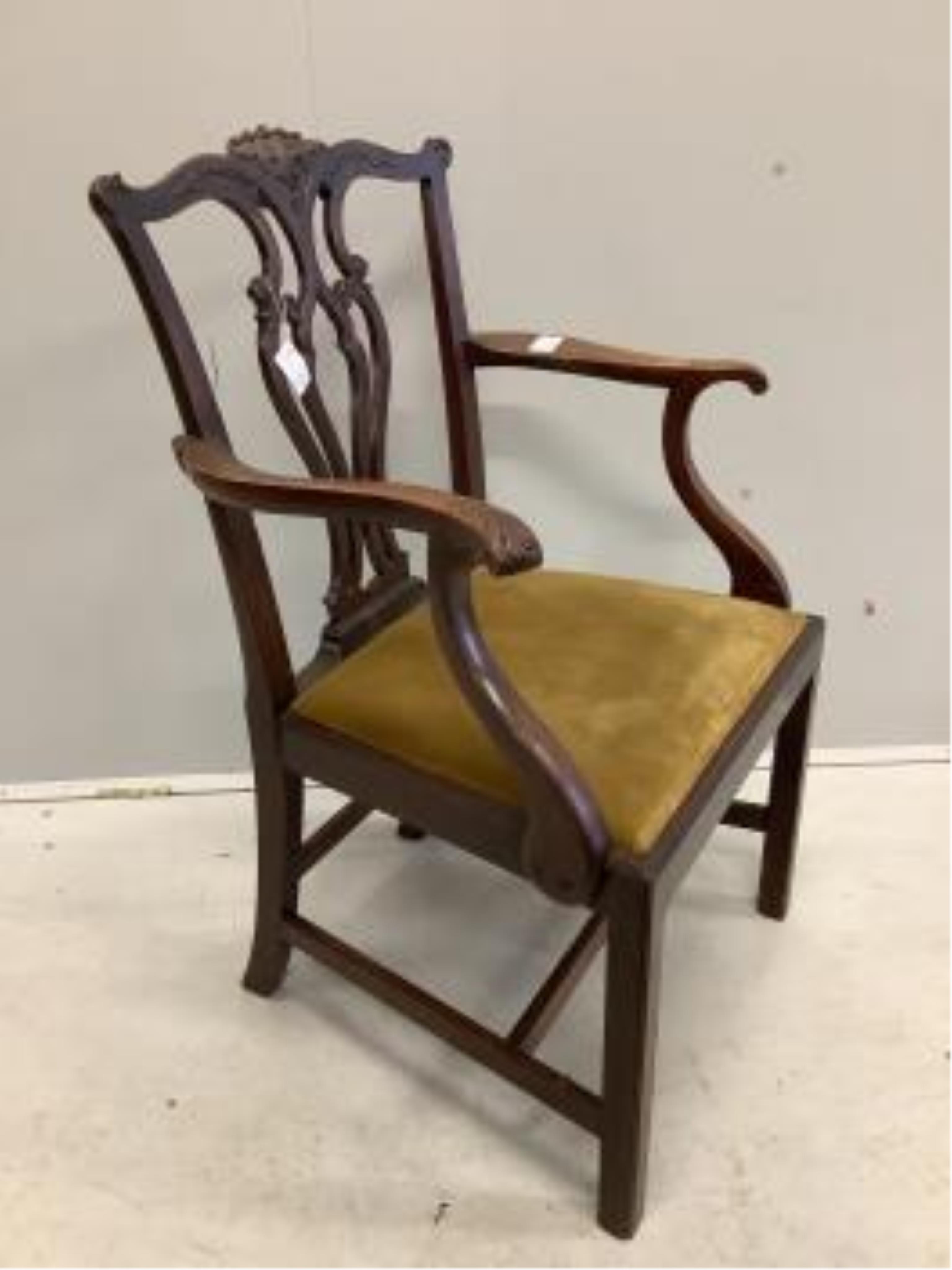 Four Chippendale style mahogany dining chairs, with pierced, interlaced splats above old gold velour drop in seats, one with arms. Condition - fair